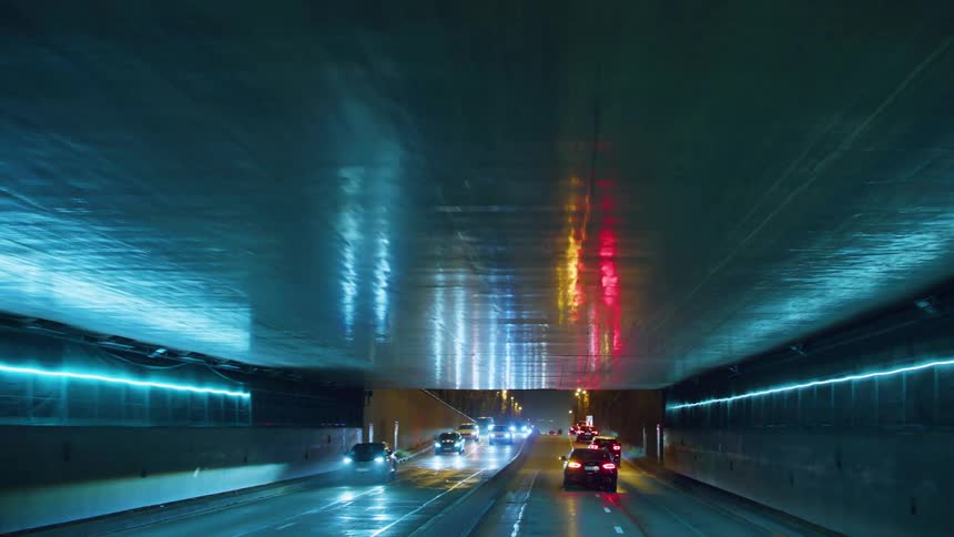 Vehicle traffic passing through a tunnel at night