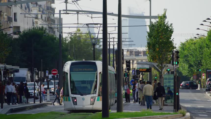 Pedestrians and headed towards the train terminal through the city