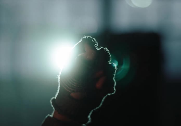 Close in a persons hand pressing a padlock that is in his hand