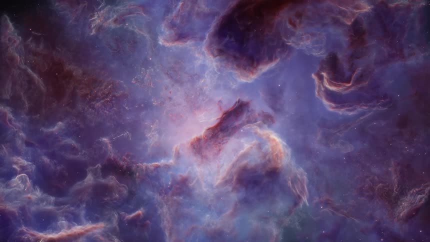 In the darkness of outer space a cloudylooking nebula is visible