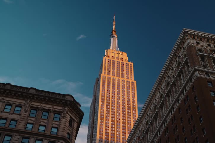 View of the empire state building on a blue sky day