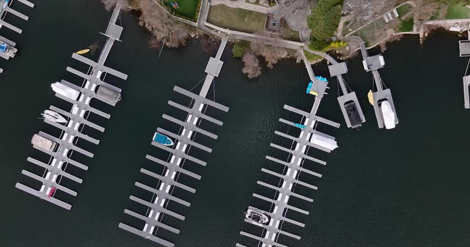 Aerial panorama of seaside mansions with exits to docks and yachts