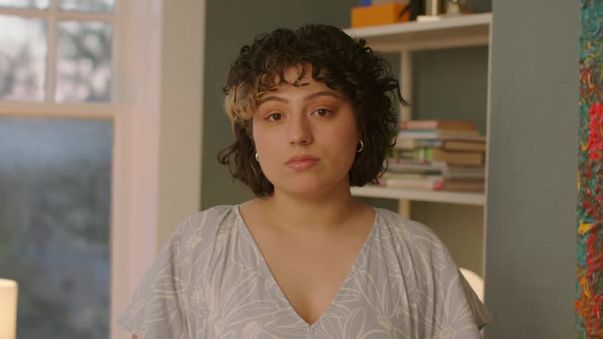 Face of a lady standing in a room at midday