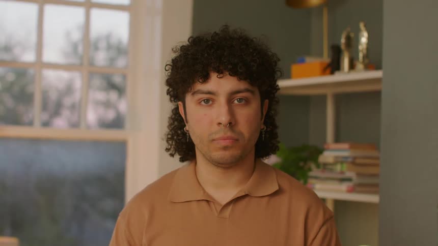 A man standing with a serious look
