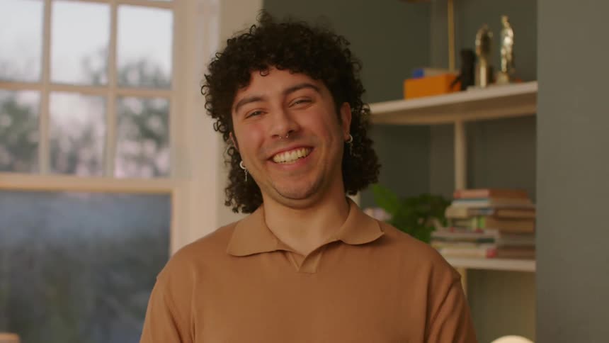 Closeup of a mans face smiling in a room