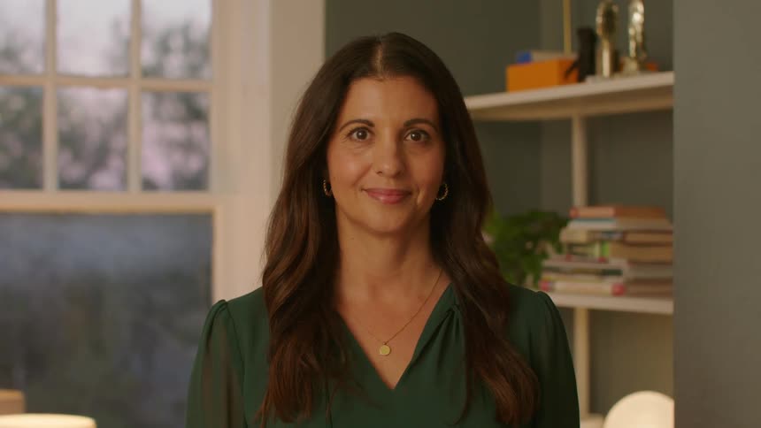 Portrait of a woman indoors smiling slightly