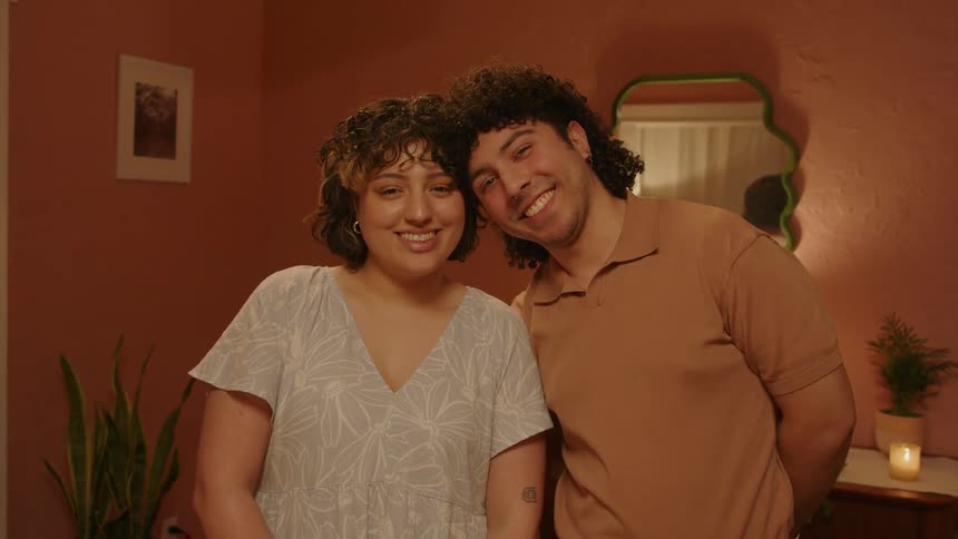 Man standing catching his head on his romantic smiling partner