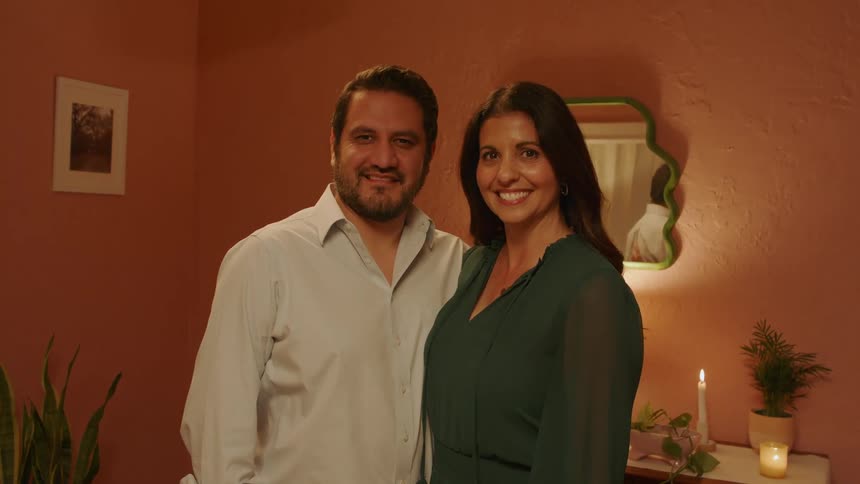 A stationary couple is looking forward while landing and both are smiling