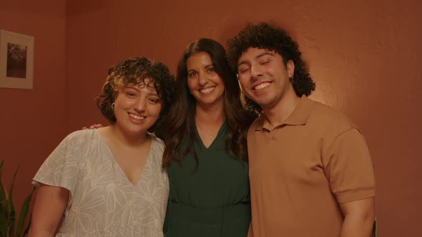 A mom and her kids smiling
