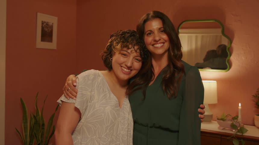 Mother and daughter smiling in a loving embrace