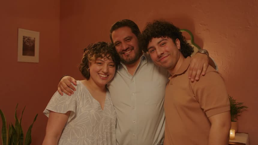 A father and his adult children smiling together