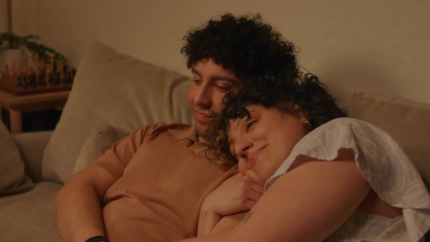 Couple sitting on the sofa hugging each other