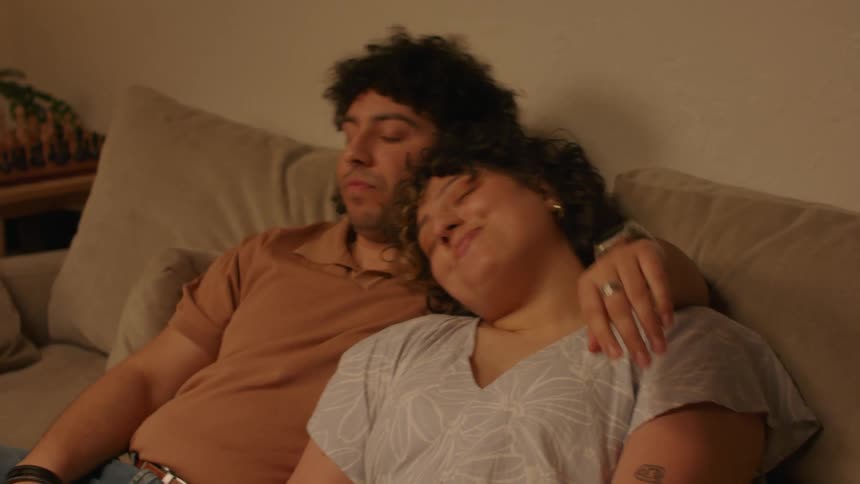 A couple of lovers hugging each other sitting on the sofa