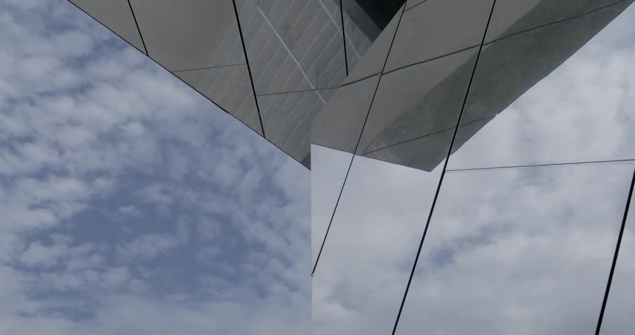 A structure with several reflecting mirrors and a person walking