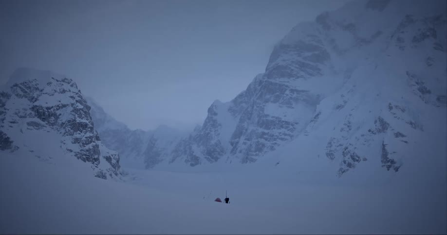 A person alone on a snow covered valley