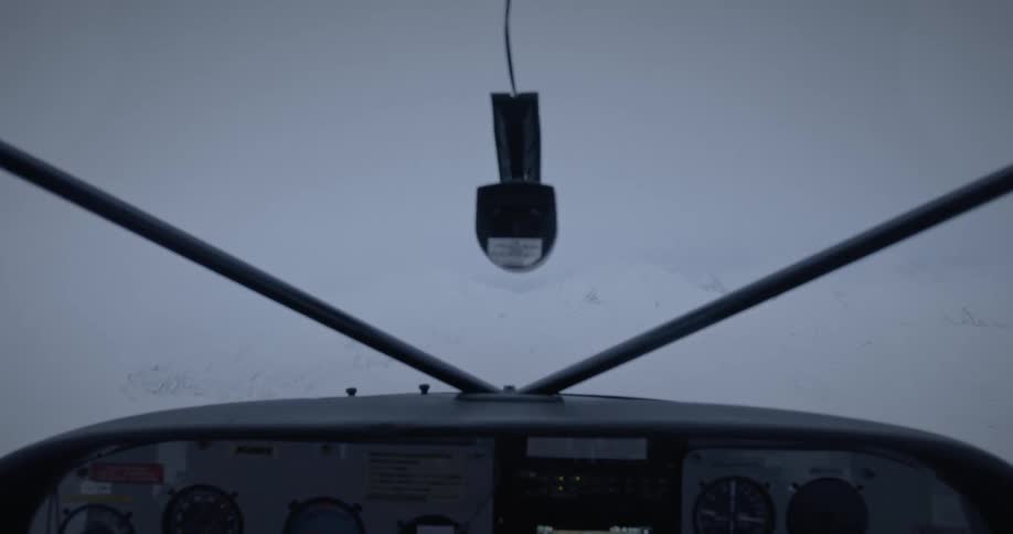 View of an airplane control panel flying over ice mountains