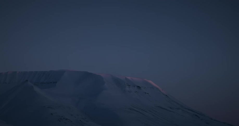 Landscape of a snowy mountain at dusk