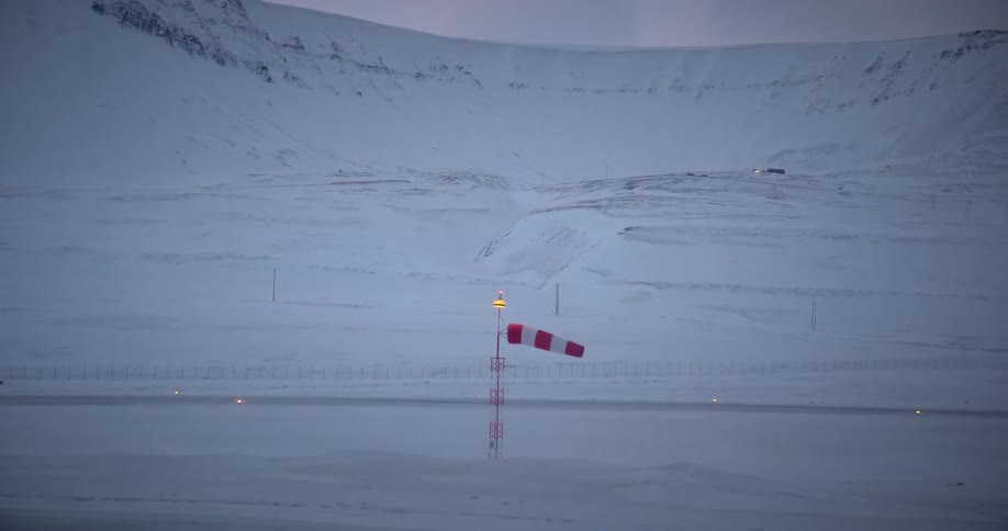 A signal flag in the frozen sea on the coast of an ice mountain