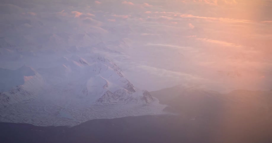 Aerial of glacial mountains in the arctic during sunset