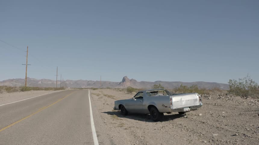 Silver el camino sitting roadside  in a desolate area