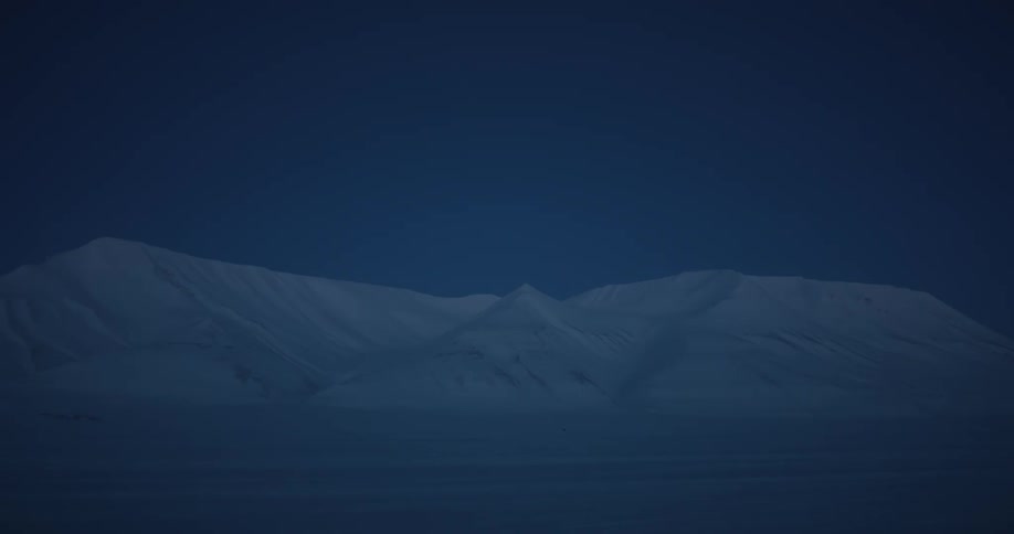 Landscape of snowy mountains at dusk