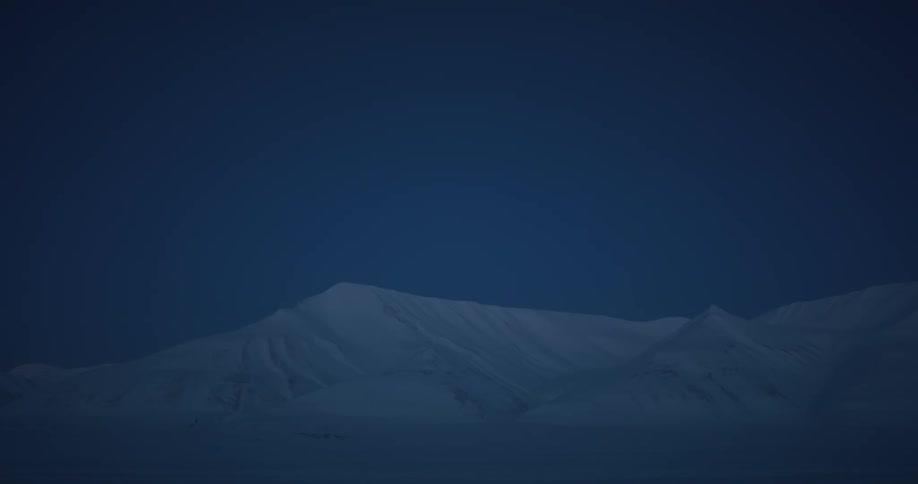 Landscape of snowy mountains at dusk