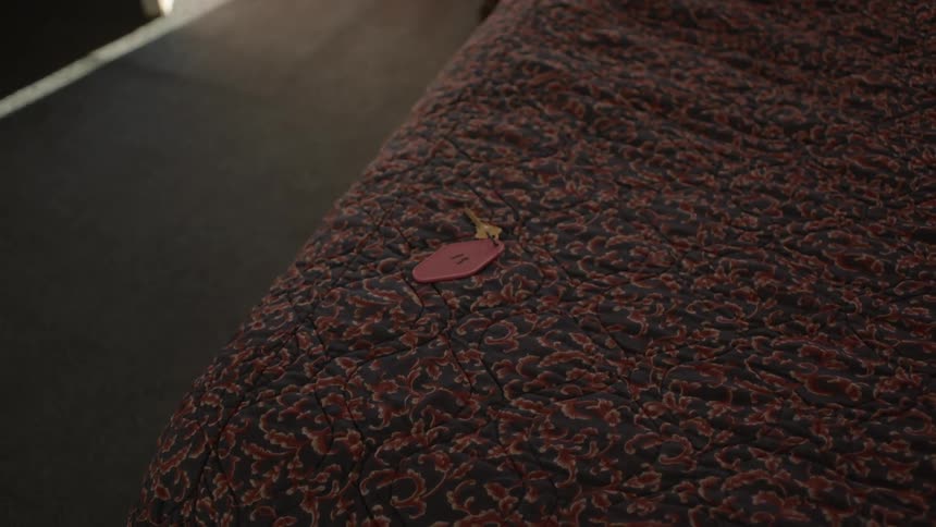 A key sits on a table alone