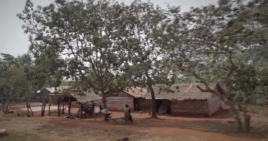 View of wooden houses amidst nature on a cloudy day