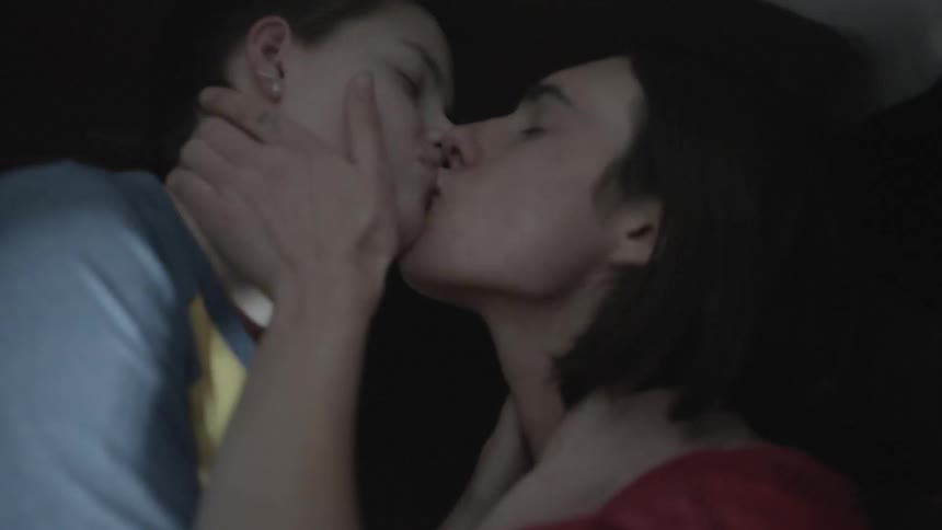 Two teenagers are kissing