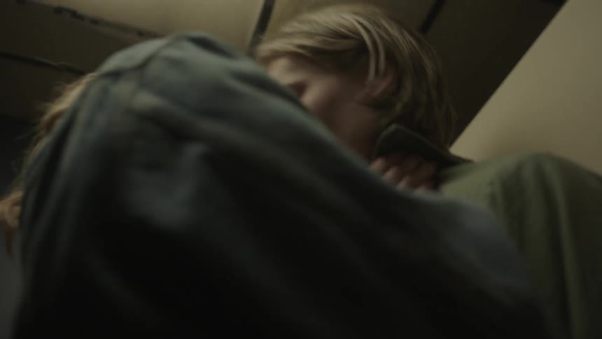 A man and woman are making out in a bathroom stall