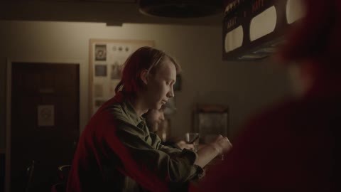 People sit at a bar together with their drinks