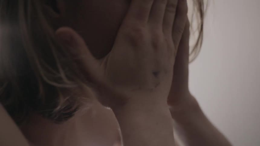 A woman is upset putting her head in her hands