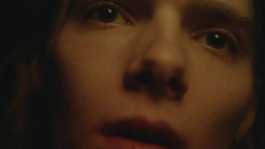 Bright and colorful lights are flashing on a teenager's face