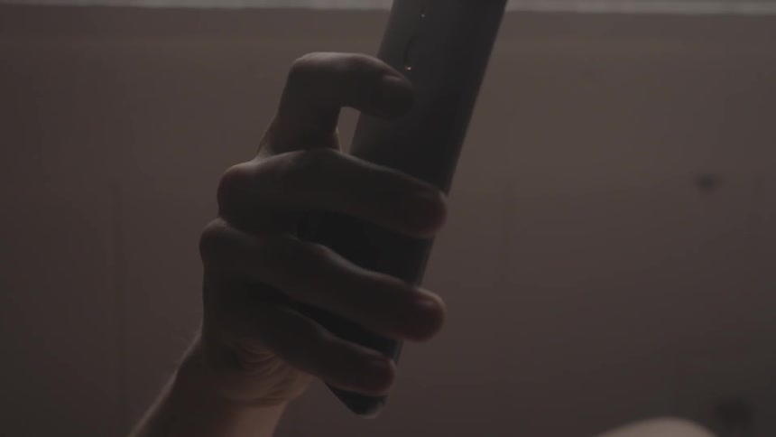 A person is holding an item above his head