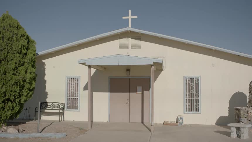A cross sits on top of a church