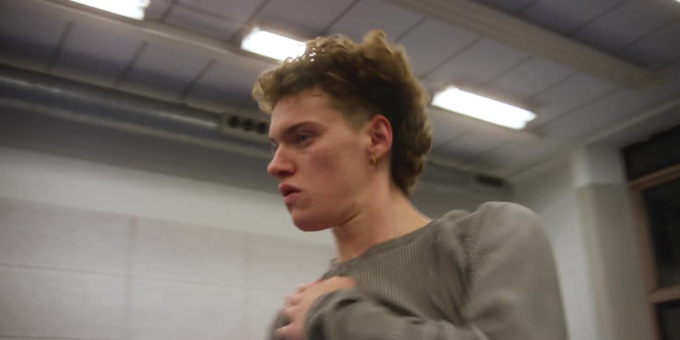 A man dancing around in a studio at night