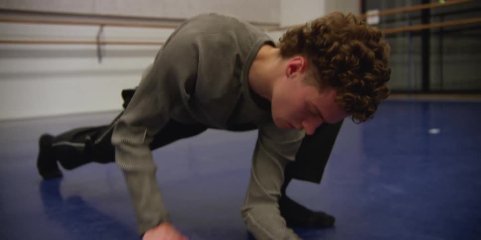 A man stretching in a gym