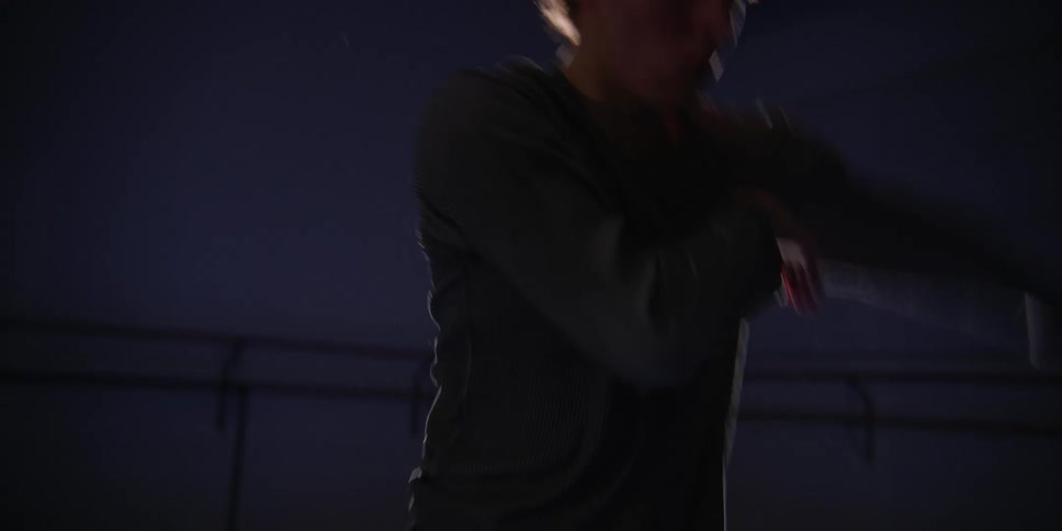A man dances vigorously in a room