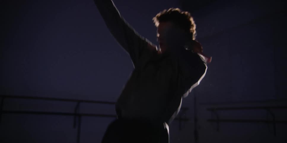 A man dancing around in a studio