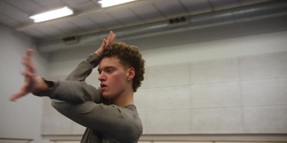 A dancing man moves in an empty room