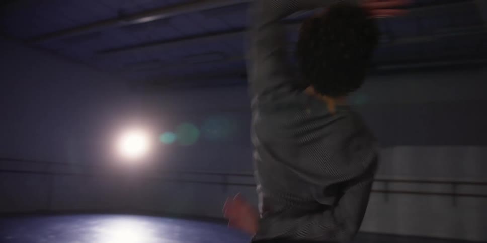 A man is dancing in the dark room