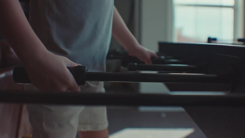 A young boy playing table football