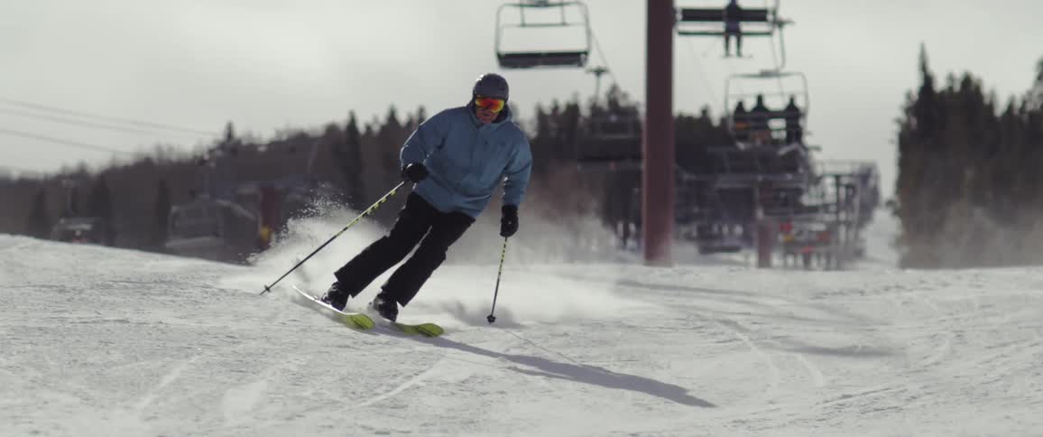 Person skiing down the mountain covered in snow