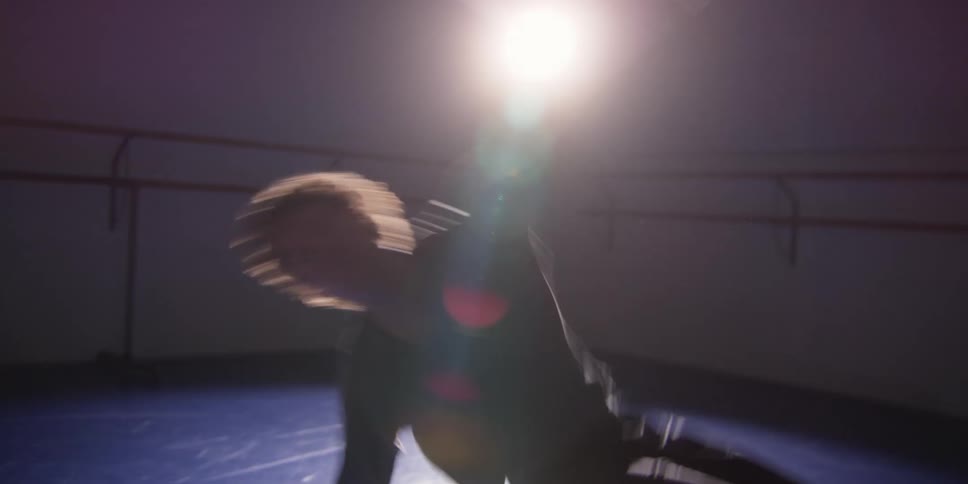 Man dancing while doing flips in a studio