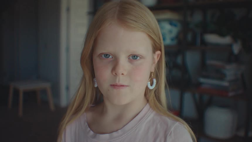 A girl brushes her hair back