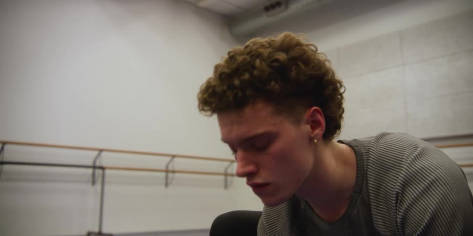 A dancer is stretching in the studio