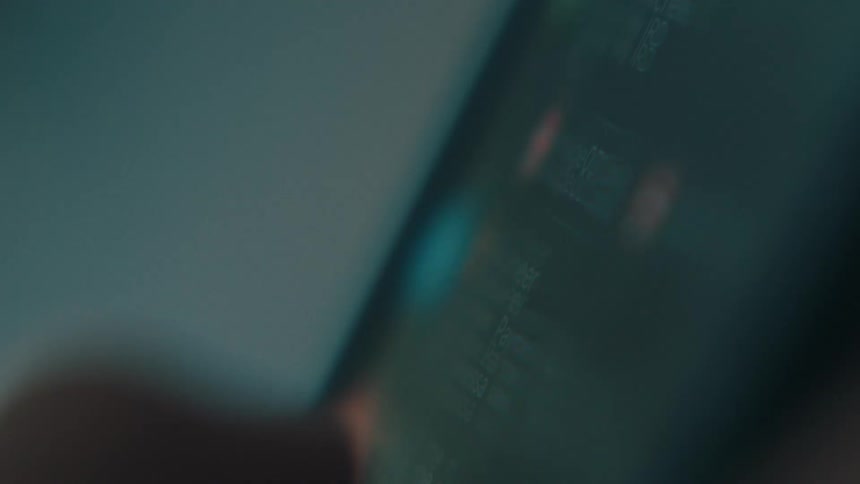 A person uses their thumb to continuously scroll through a list on their smart phone
