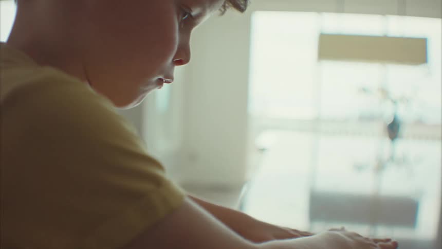 Portrait of a boy making a paper airplane