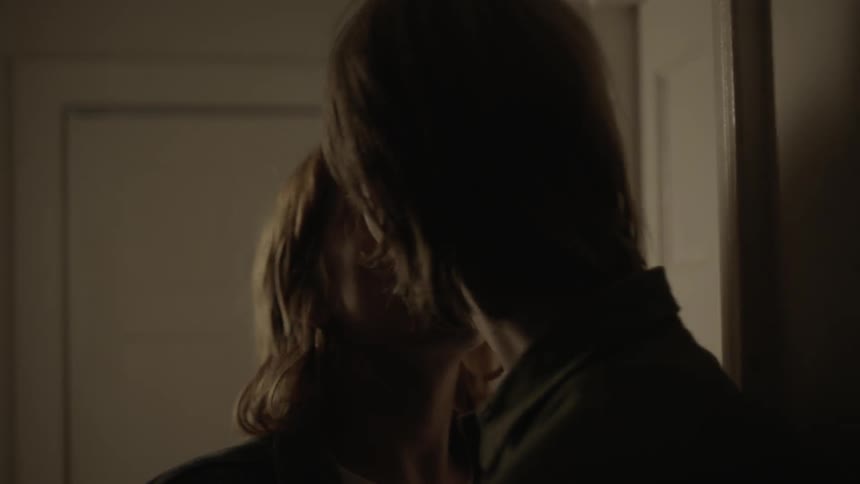 Man and woman kissing and going into a room