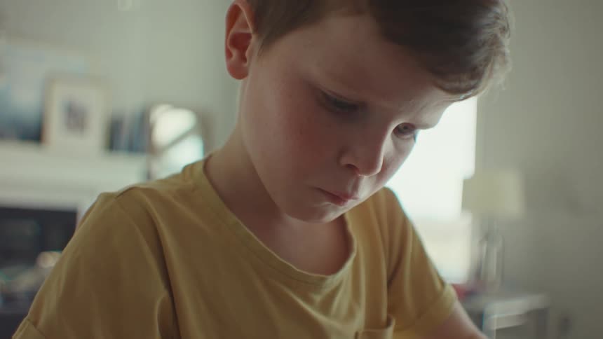 A clip of a boy in a room